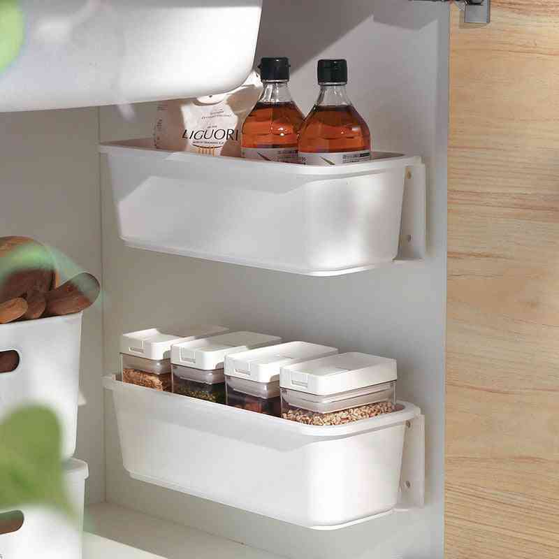 Two-tier under sink storage rack used for organizing household cleaning products