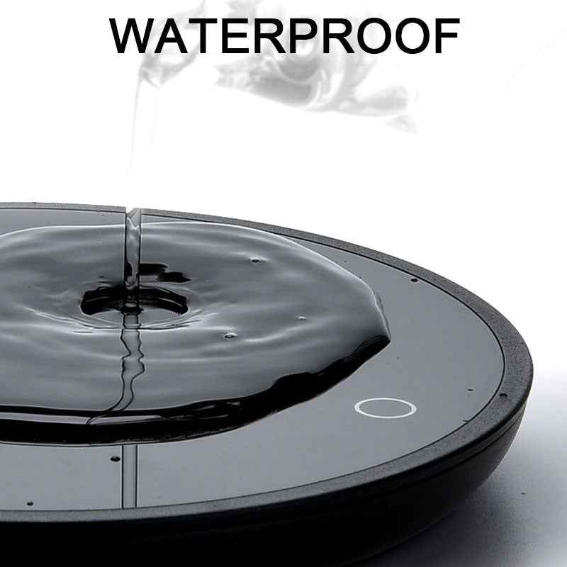 Waterproof coffee mug warmer surface with water being poured, ensuring safe heating of beverages in home or office settings.
