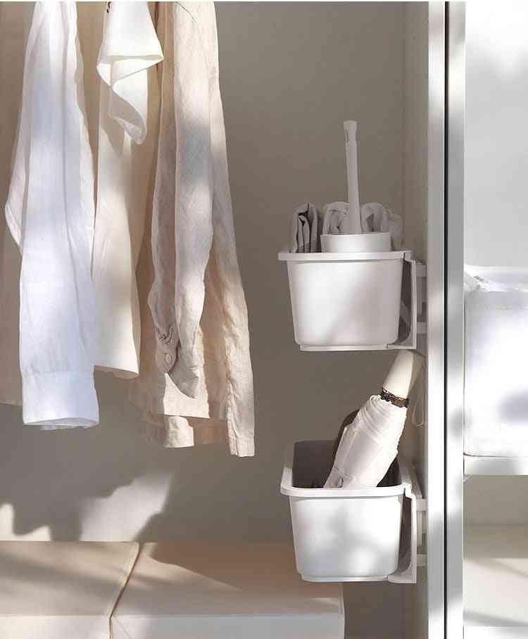 Pull-out cabinet organizer showing neatly arranged kitchen essentials under the sink.