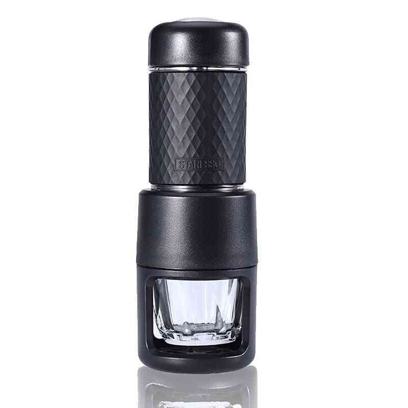Black portable manual espresso coffee machine with clear glass cup. Smart kitchen essential for rich espresso anywhere.