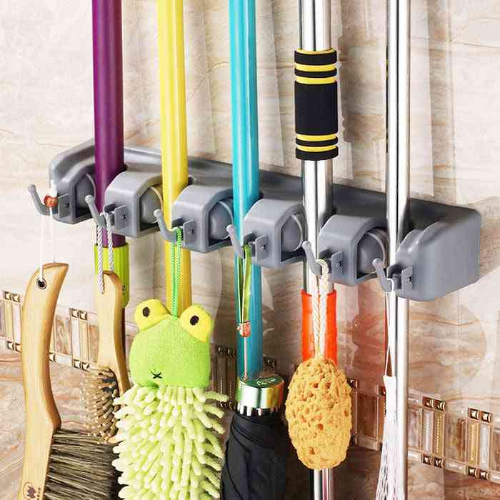 Plastic Mop Hook – Wall Hanging Multifunctional Cabinet Holder storing colorful mops, brushes, and sponges. Great for smart kitchen and bathroom organization.