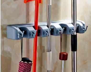 Plastic Mop Hook – Wall Hanging Multifunctional Cabinet Holder mounted on wall, holding various cleaning tools. Smart kitchen essential for clutter-free storage.