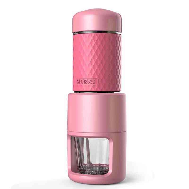 Pink manual espresso coffee machine with textured grip and clear cup. Compact and colorful for travel and home use.