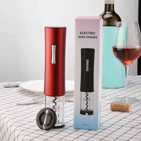 Red electric wine opener with foil cutter and packaging on dining table. Automatic corkscrew kit perfect for elegant wine service.