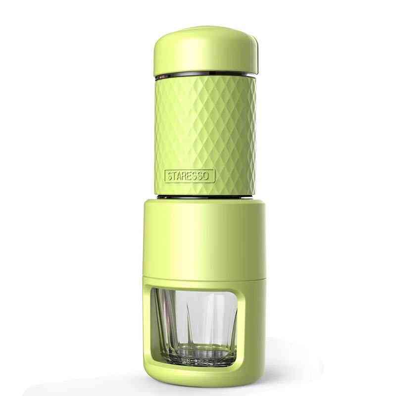 Green manual espresso coffee machine with textured grip and clear cup. Portable design for rich espresso anywhere.