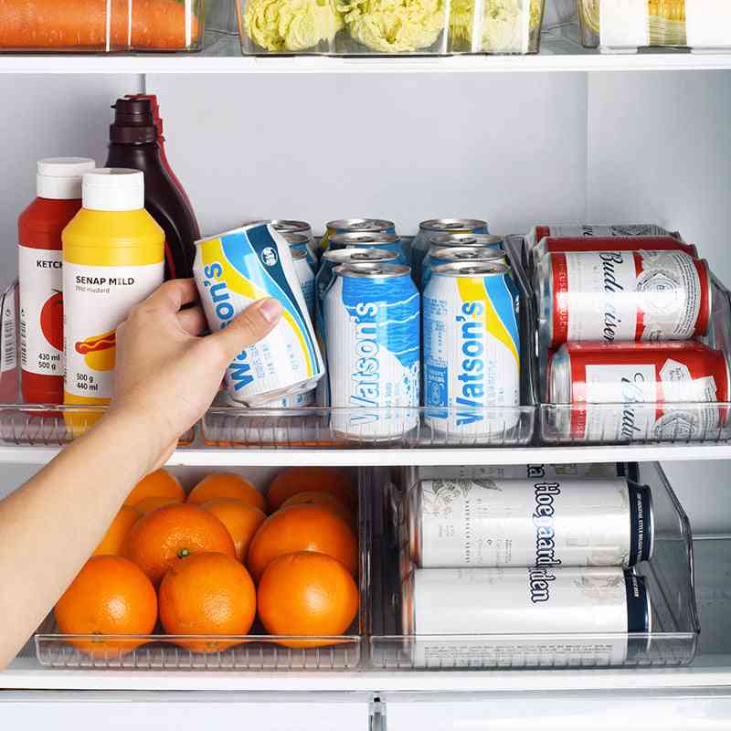 Refrigerator beverage organizer holding multiple soda cans and bottles, maximizing fridge space with a transparent and stackable design.