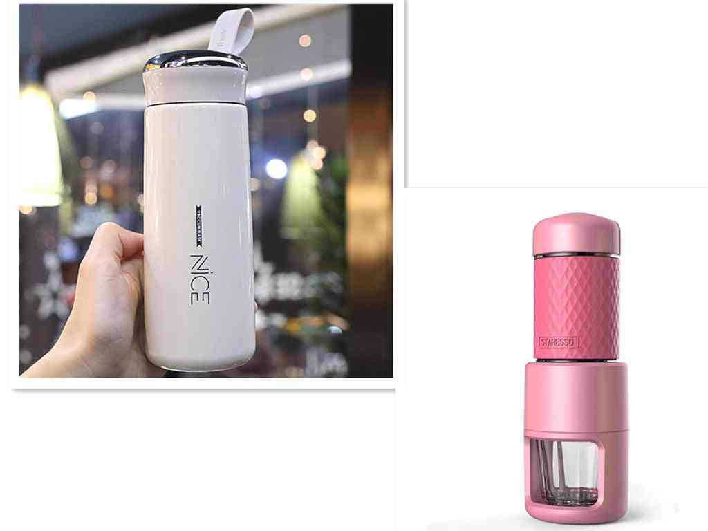 White travel mug next to a pink manual espresso coffee machine. Portable espresso maker for stylish coffee preparation.