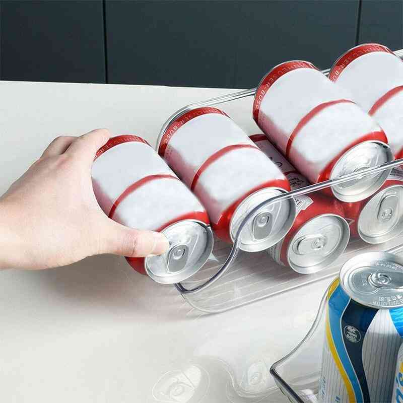 Clear fridge drink holder being used to load soda cans, showcasing easy access and organized storage for beverages in the kitchen.