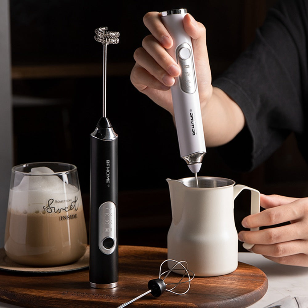 Electric Milk Foam Maker – Portable Coffee Frother for Creamy Foam shown frothing milk in a white jug with a sleek black and silver design. Ideal for lattes, cappuccinos, and hot chocolate preparation.
