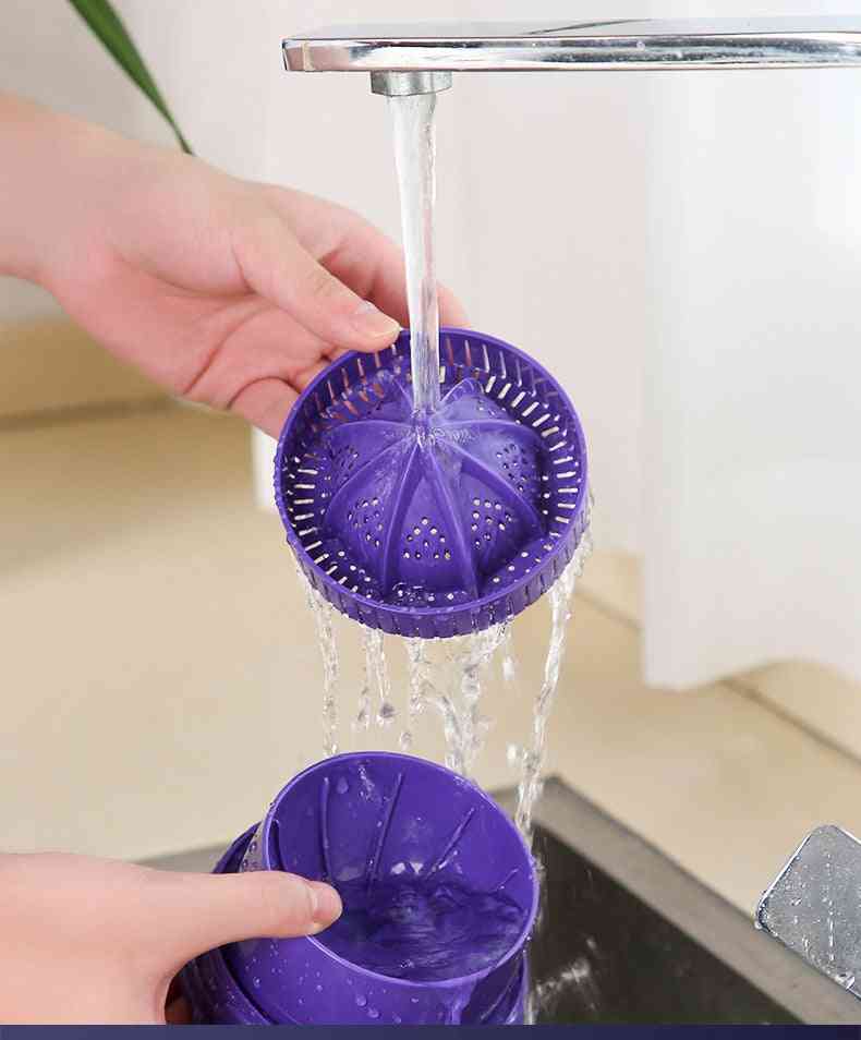 Detachable parts of the electric orange juicer being washed under running water, highlighting easy cleaning and maintenance.